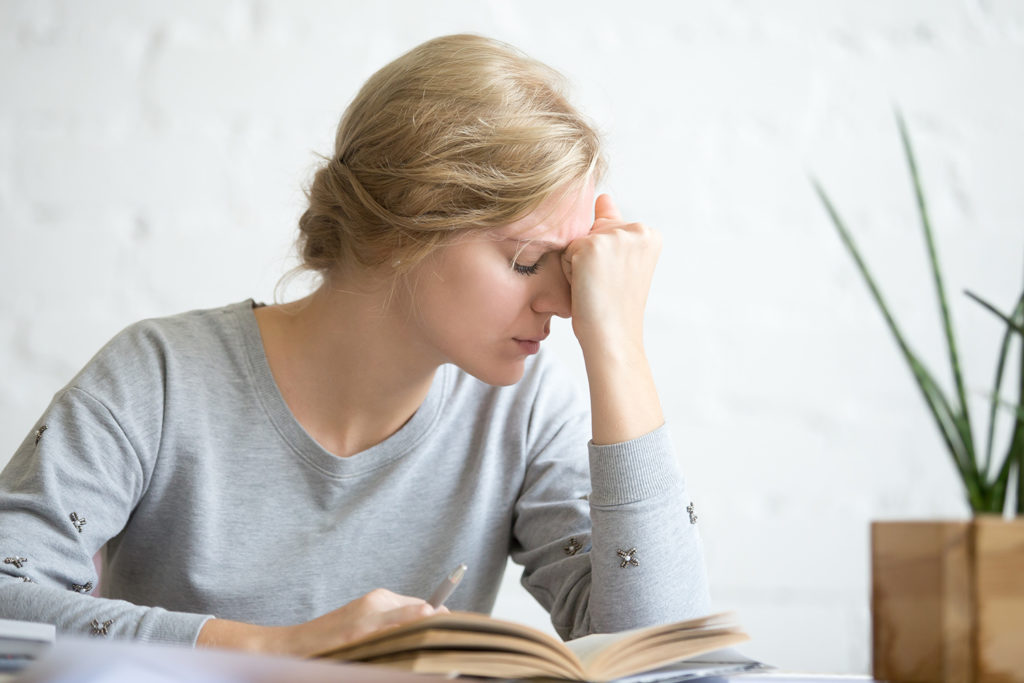 woman suffer from vertigo while reading a book