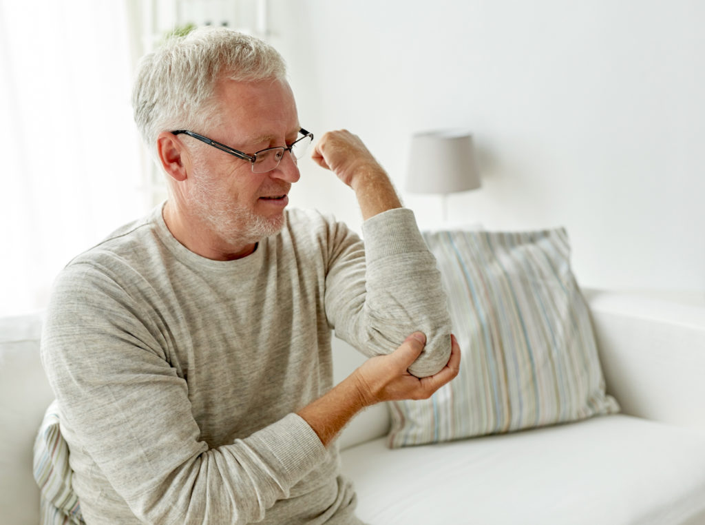 old man endure his elbow pain