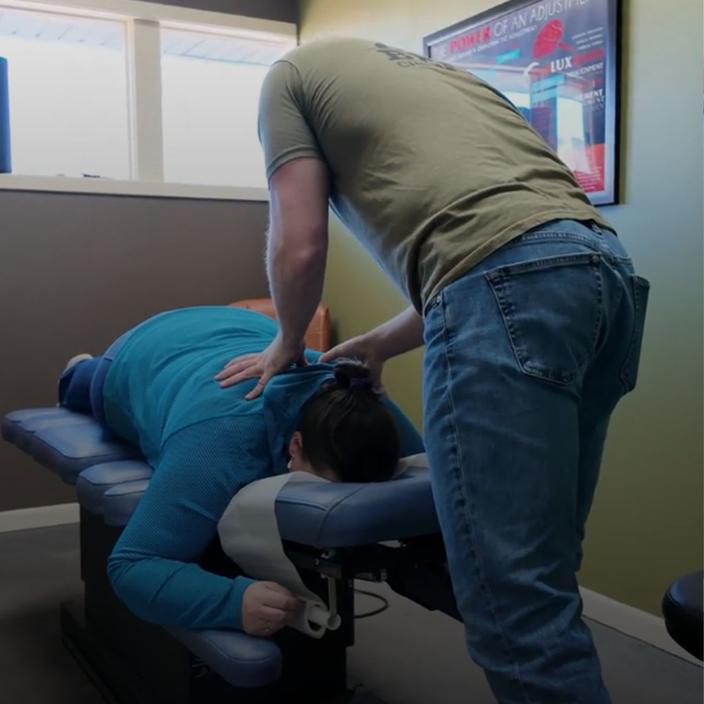 Dr. Aaron Zimmerman attend to female patients poor posture