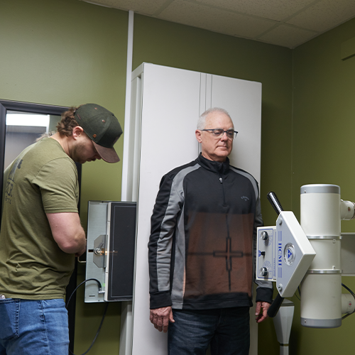 Dr. Aaron Zimmerman doing a spine xray on male patient